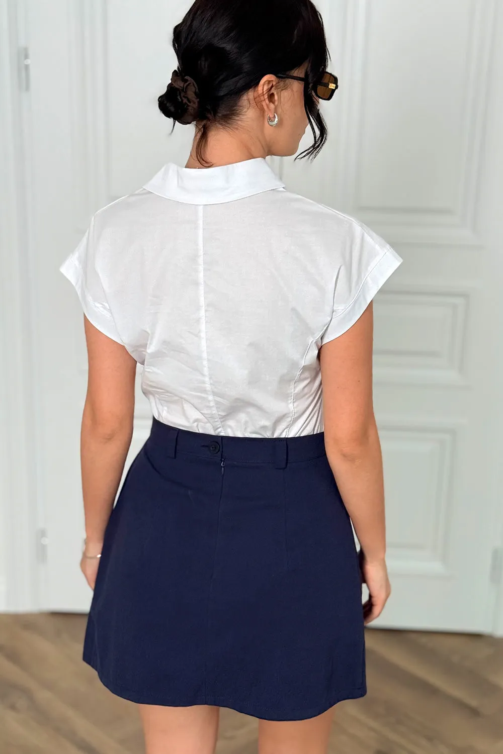 Blue A-line skirt with elegant pleats at the front